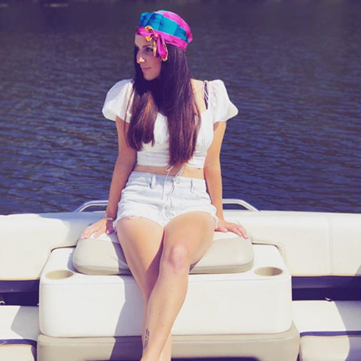 katie wears Bold Clothing's Band of gold Headwear on a boat |  #sayitinbold @boldornaked shop online at www.boldornaked.com | Bold Headwear